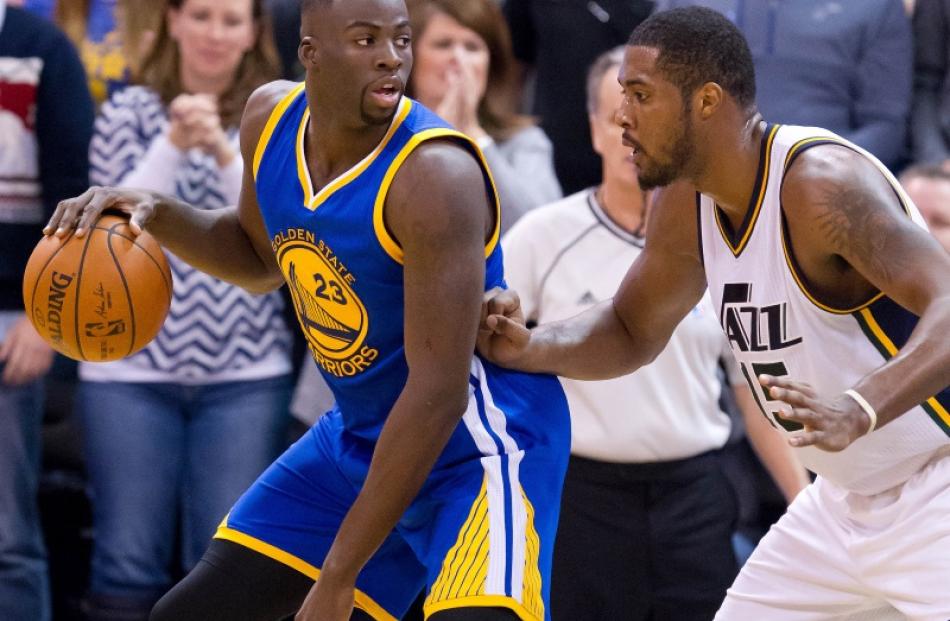 Warriors forward Draymond Green posts up against Jazz forward Derrick Favours in the Warriors...