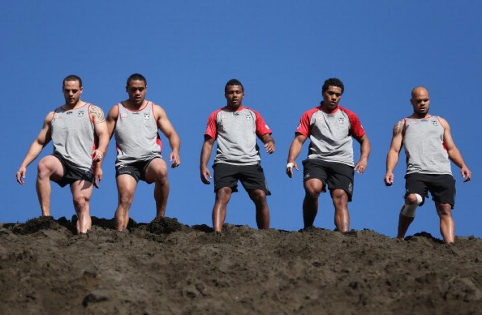 Warriors players take part in a training session at Bethells Beach in Auckland. Photo Getty Images