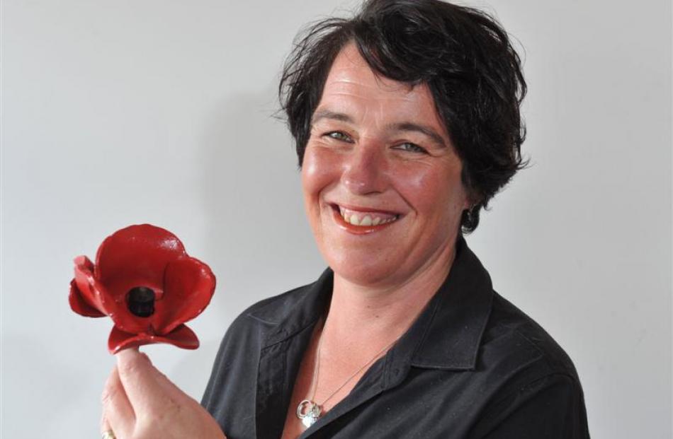 Wendy Boyne, of the Mosgiel RSA, holds the Tower of London Ceramic Poppy  given  to the Mosgiel...