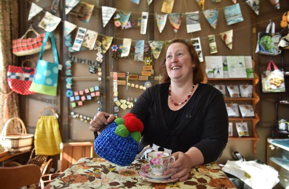 Whimsy owner Barbara Bennett, of Wakari, pours a cup of tea in her upstairs shop at the market.