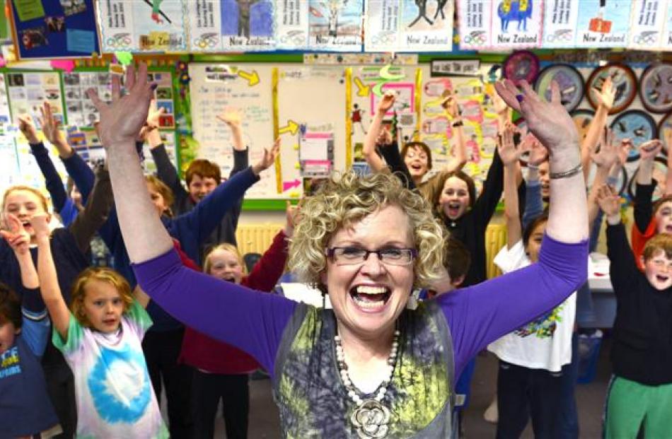 Winner of this year's most inspiring teacher award Jan Stevens celebrates with pupils from the...