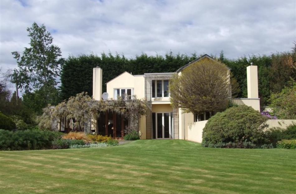 With a shelter belt behind it and sweeping lawns in front, the Clelands' home is perfectly...