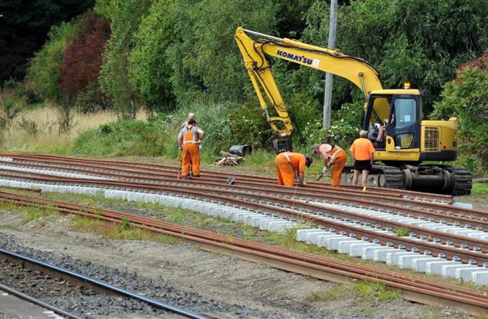 Workers assemble railway tracks at the old Wingatui rail-yard to test the safest way to replace...