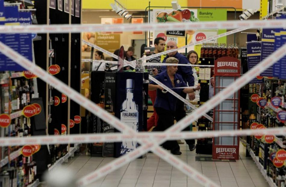 Workers puts tape to close an aisle with hard liquor in a supermarket in Prague. REUTERS/David W...
