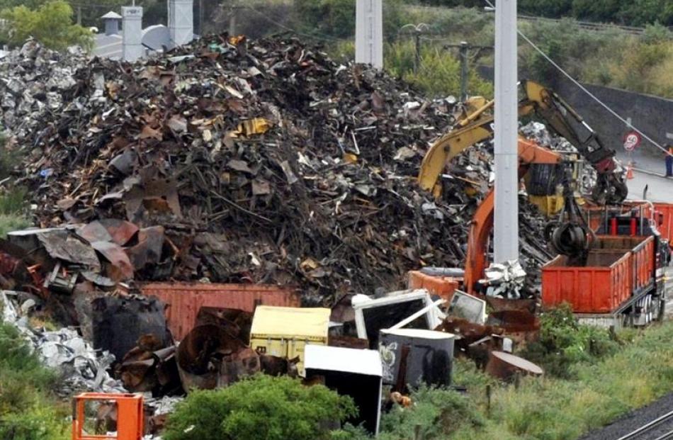 Workers toil through Friday and Saturday to transfer a 4500-tonne pile of scrap at Everitt...