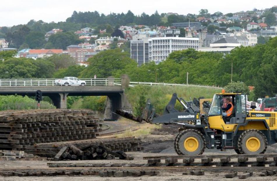 Workmen clear Doug Hall's site at the corner of Anzac Ave and State Highway 88, Dunedin,...