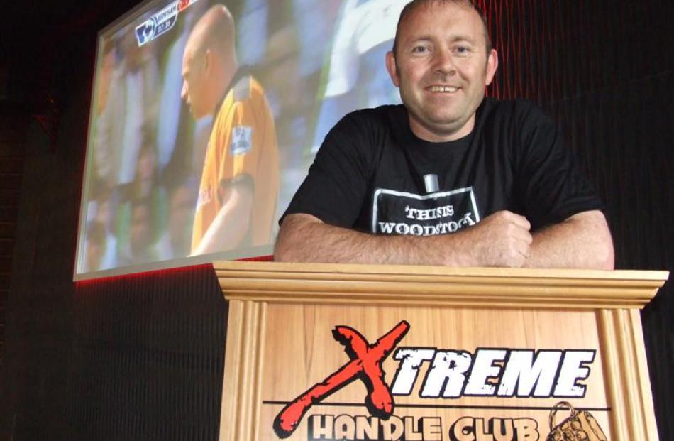 Xtreme Sports Bar's projector screen provides a backdrop to  Dwayne Quirk, of Queenstown,  who, ...