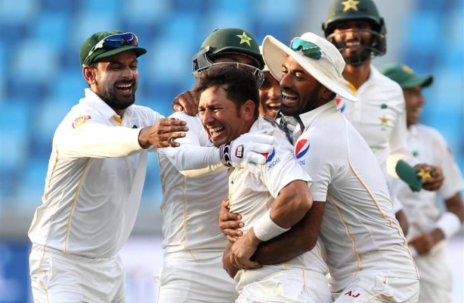 Yasir Shah celebrates taking the final wicket of England's Adil Rashid. Photo: Reuters