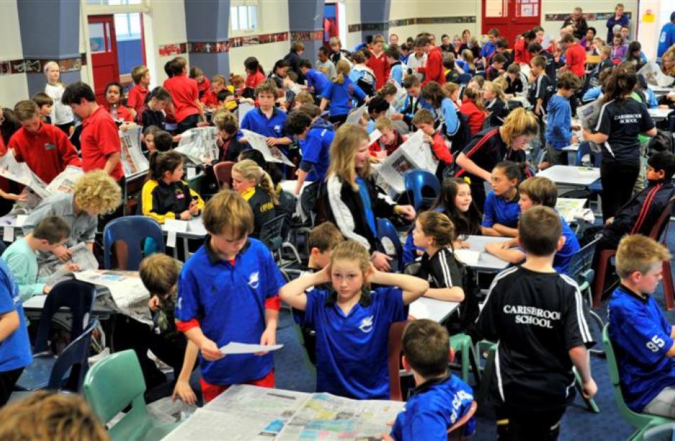 Years 5 and 6 pupils rush to find answers from the Otago Daily Times in the ODT Extra! Otago...