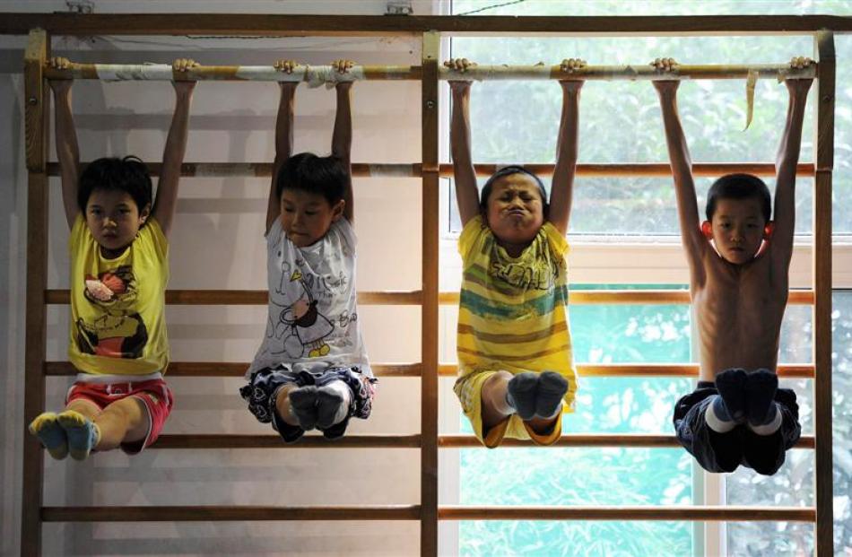 Young divers attend a training session at a gymnasium in Hefei, China. REUTERS/Stringer