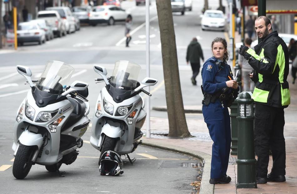 A policewoman speaks to a Dunedin parking warden who was allegedly assaulted during a dispute in...