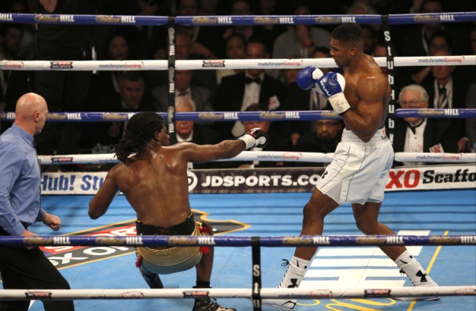 Anthony Joshua knocks down Charles Martin. Photo: Reuters