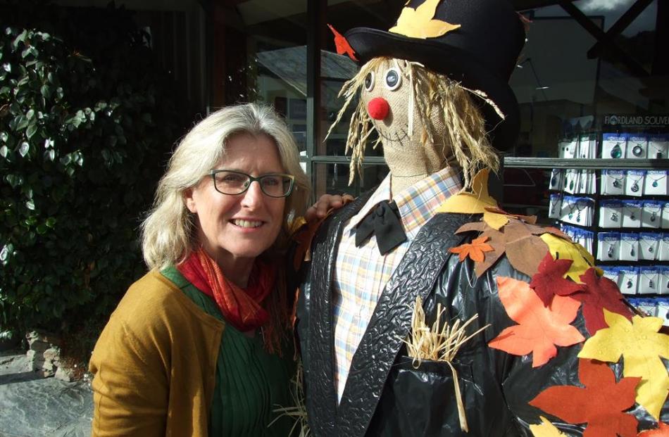 Arrowtown Autumn Festival co-ordinator Pip Norton with a scarecrow made by Helen Patterson,...