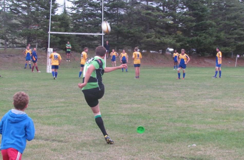 Craig Smith, who was playing cricket for Otago just a few weeks ago, kicks a goal for Maheno in...