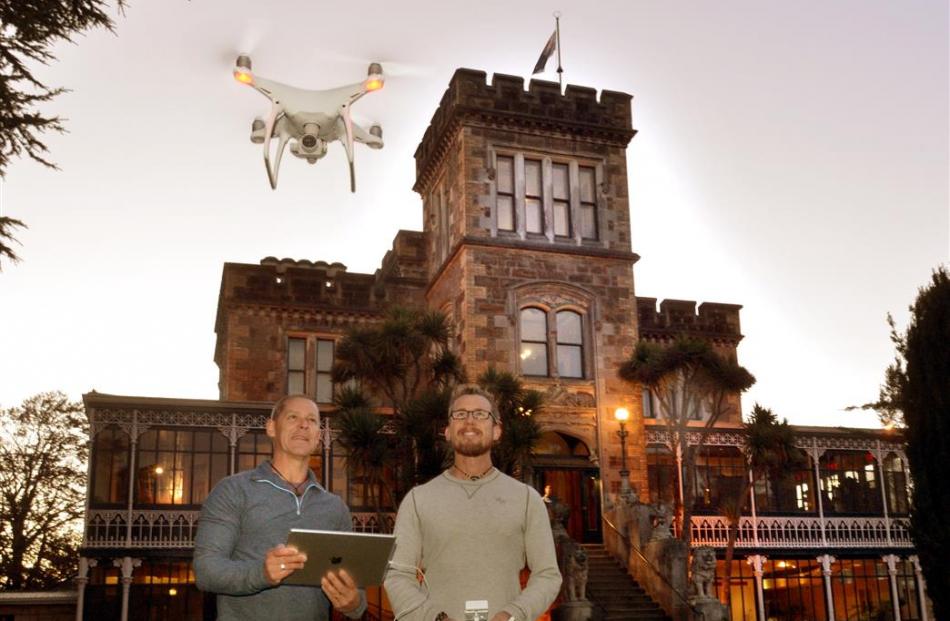 Curtis Simmons (left) and Trey Ratcliff operate a drone that sent video footage of Larnach Castle...
