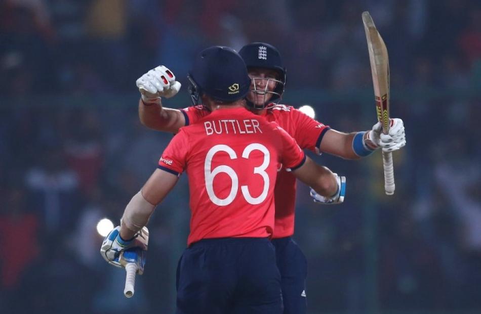 England's Joe Root (R) and Jos Buttler celebrate their team's victory over New Zealand. REUTERS...