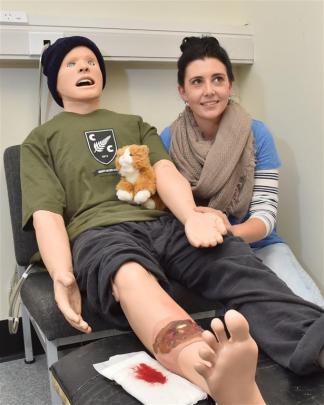 Gemma Hutton, a rural nurse specialist from Franz Josef, takes the pulse of a mannequin patient...
