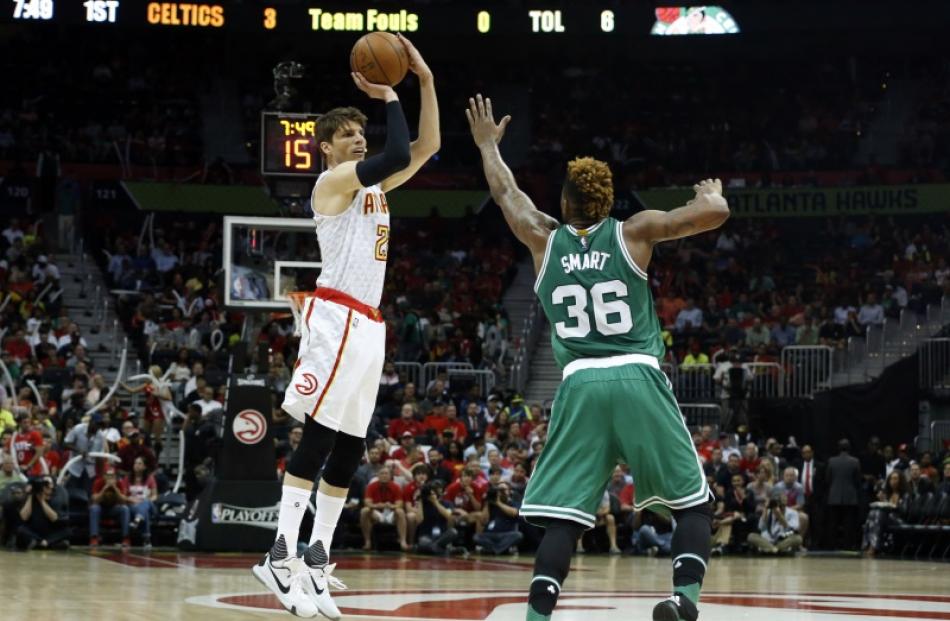 Hawks guard Kyle Korver shoots over Celtics guard Marcus Smart. Photo: Reuters