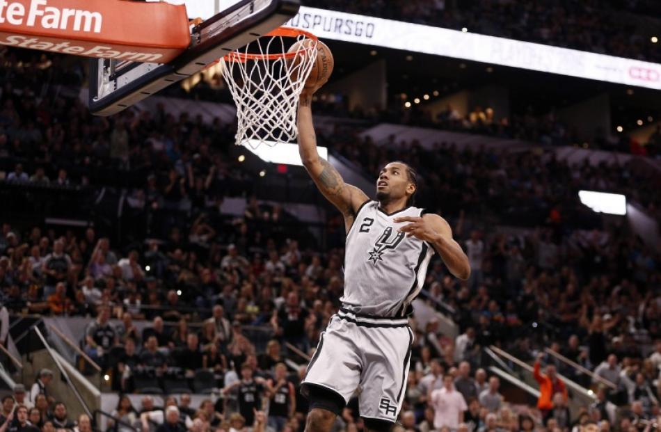 Kawhi Leonard takes the ball to the hoop for the San Antonio Spurs. Photo: Reuters