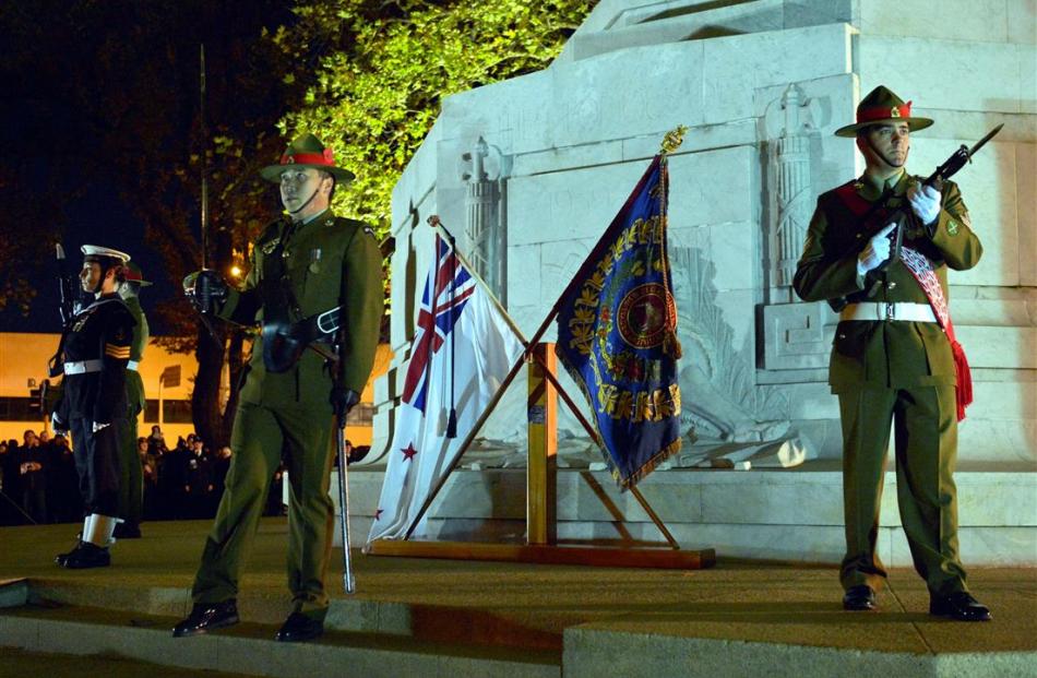 Lieutenant Bill Lu leaves the cenotaph plinth after placing the 2/4 RNZIR colours at the dawn...