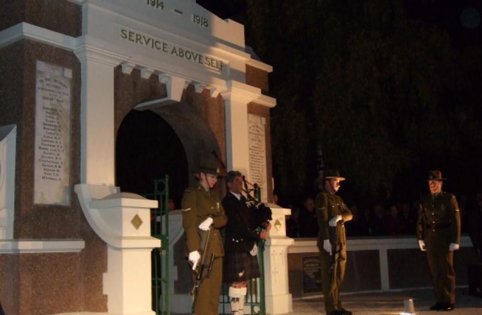 Pipe major John Teviotdale (C) plays 'Flowers of the Forest' during the Queenstown Dawn Service....