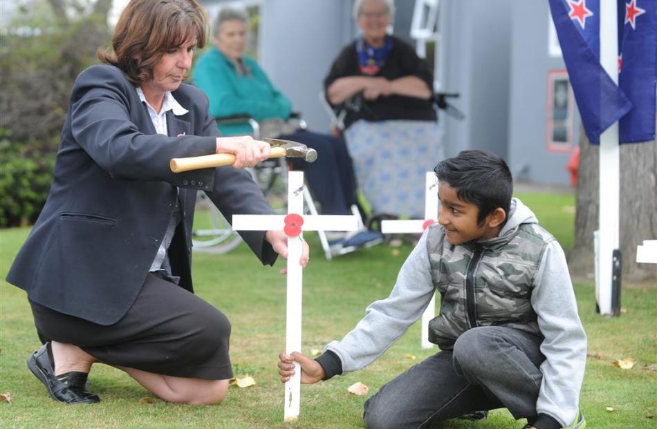 Radius Fulton Care Centre activities director Beth Sizemore, helped  by Maanveer Pillay (9), of...