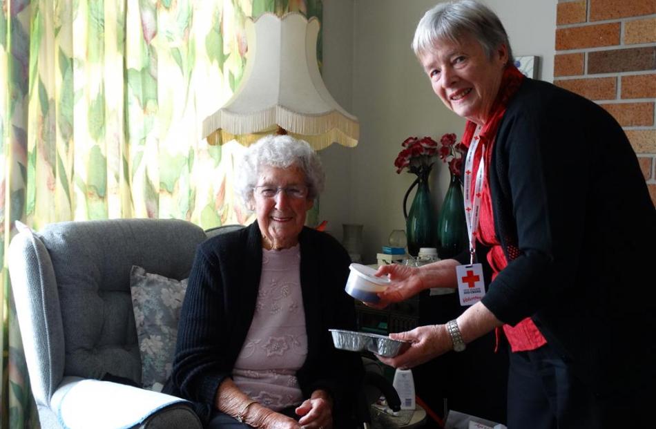 Red Cross Meals on Wheels Mosgiel volunteer Nola King gives Jan Dee her meal. Photo by Joshua...