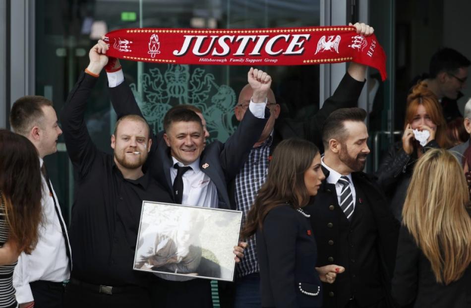 Relatives celebrate after the jury delivered its verdict in Warrington, northern England, on...