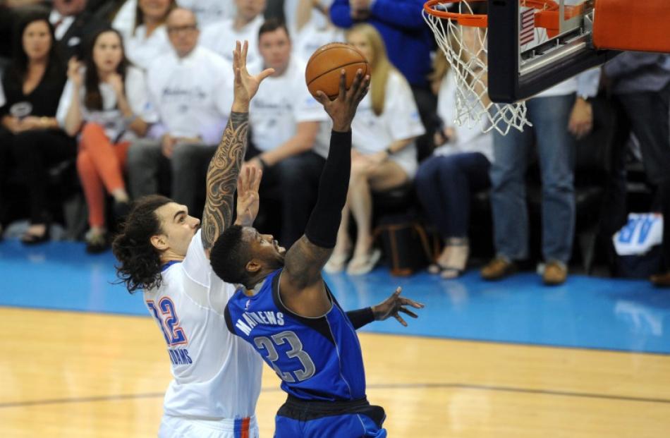 Steven Adams looks to block Wesley Matthews during the Thunder's loss to the Mavericks. Photo:...