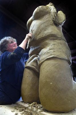 Suzanne Emslie works on one of her supersized clay figures. Photos by Peter McIntosh.