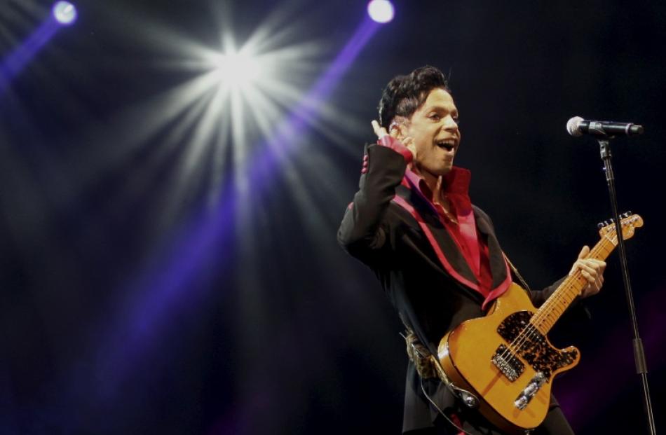 US musician Prince performs on stage at Yas Arena in Yas Island, Abu Dhabi, United Arab Emirates,...