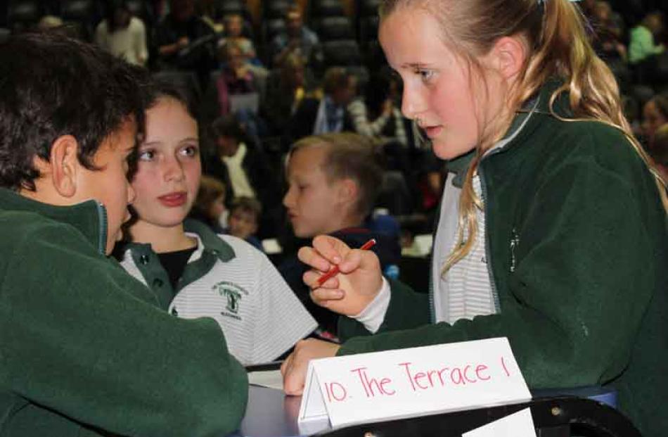 Emily Templeton (10), of the Terrace School in Alexandra, discusses answers with her teammates at...