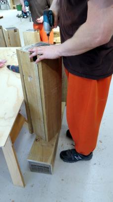 A prisoner at the Otago Corrections Facility builds a stoat trap. Photos supplied.