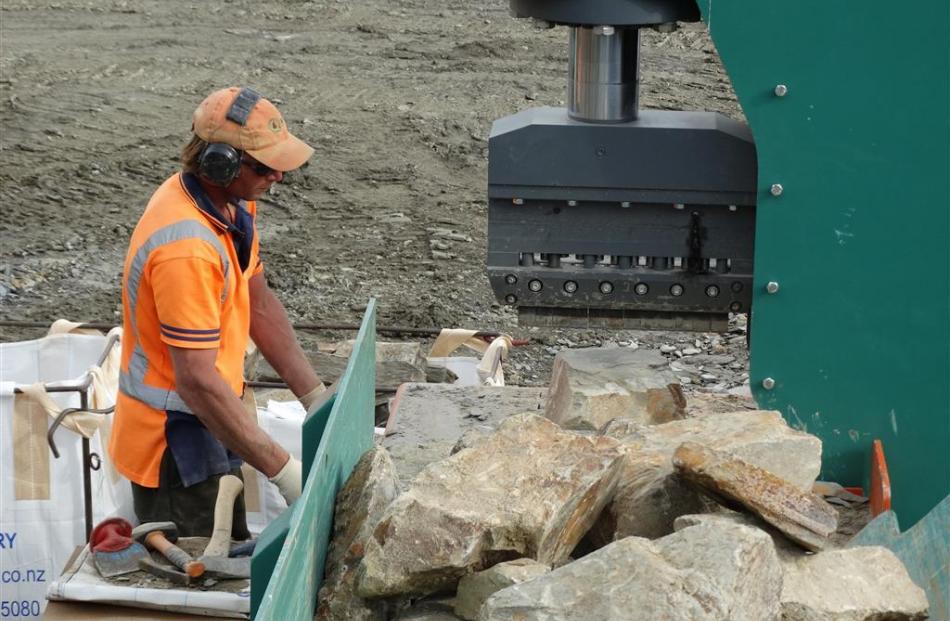 Cluden Stone Quarry employee Regan Gregg uses the quarry’s new Italian stone-cutting machine....