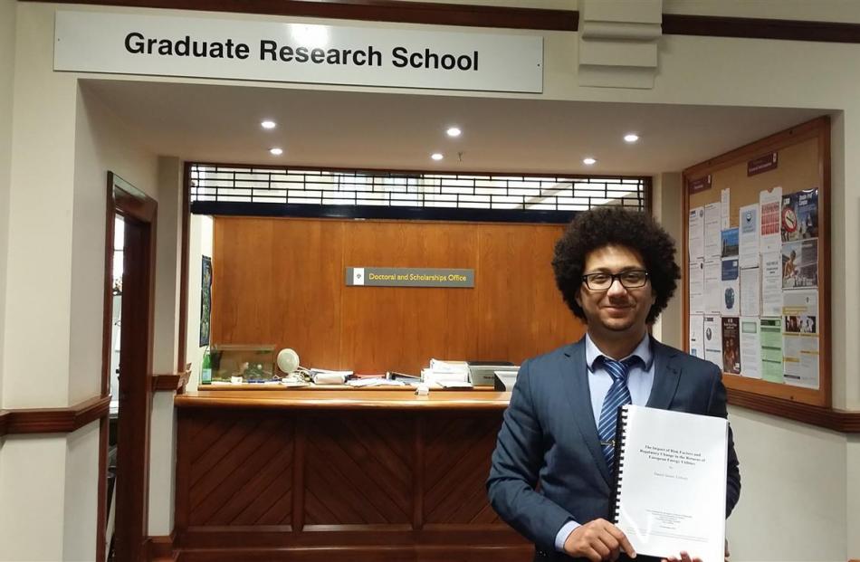Daniel Tulloch, a University of Oxford sustainable finance programme research associate, hands in...