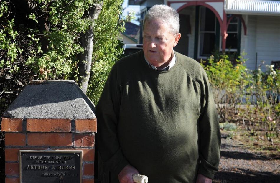 Emeritus Prof Martin Ferguson stands beside a plaque marking the site of an earlier house, once...