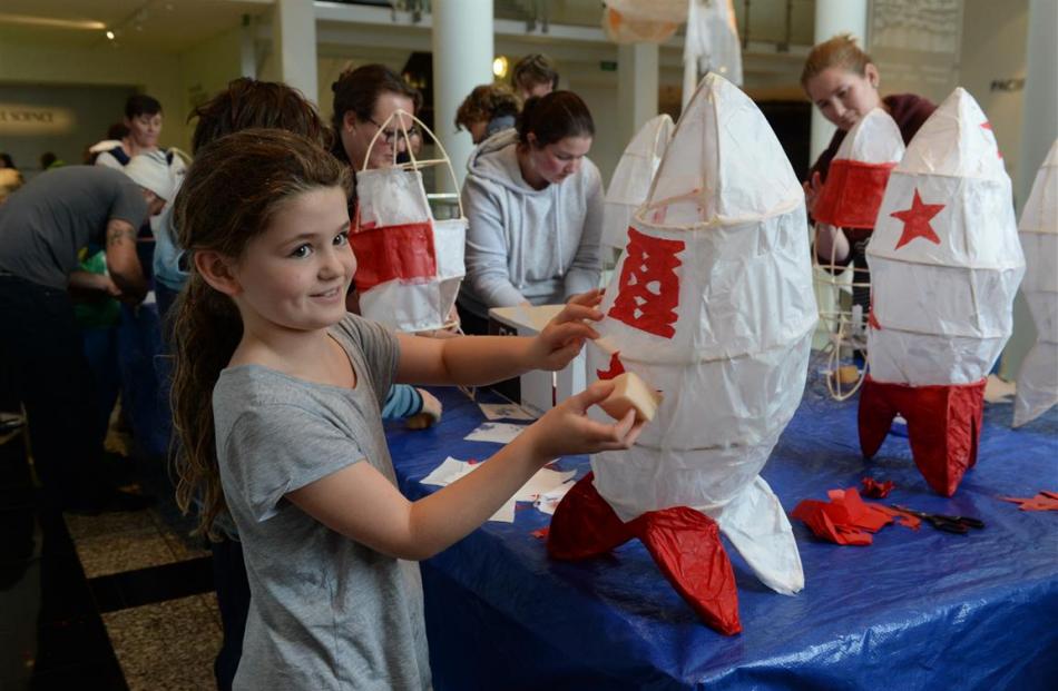 Estee Farrow (8), of Dunedin, adds the finishing touches to a rocket-shaped lantern she made at a...