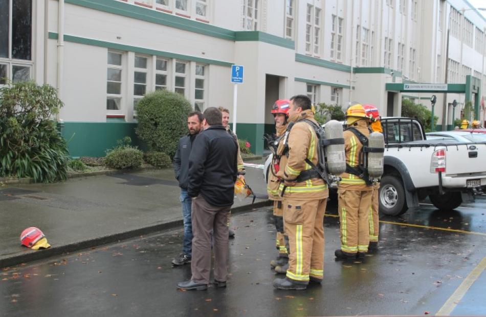 Southern Institute of Technology facilities manager Neil Smith (back to camera) talks to...