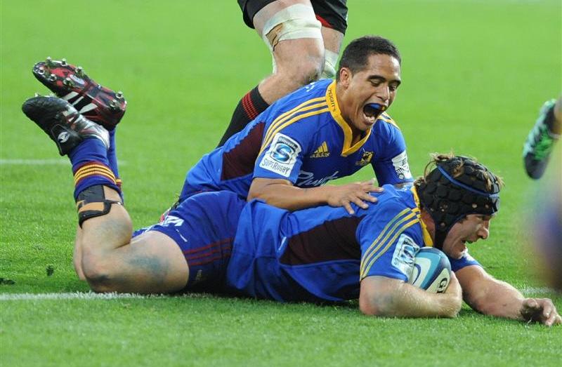 Halfback Aaron Smith congratulates Andrew Hore as he dots down.