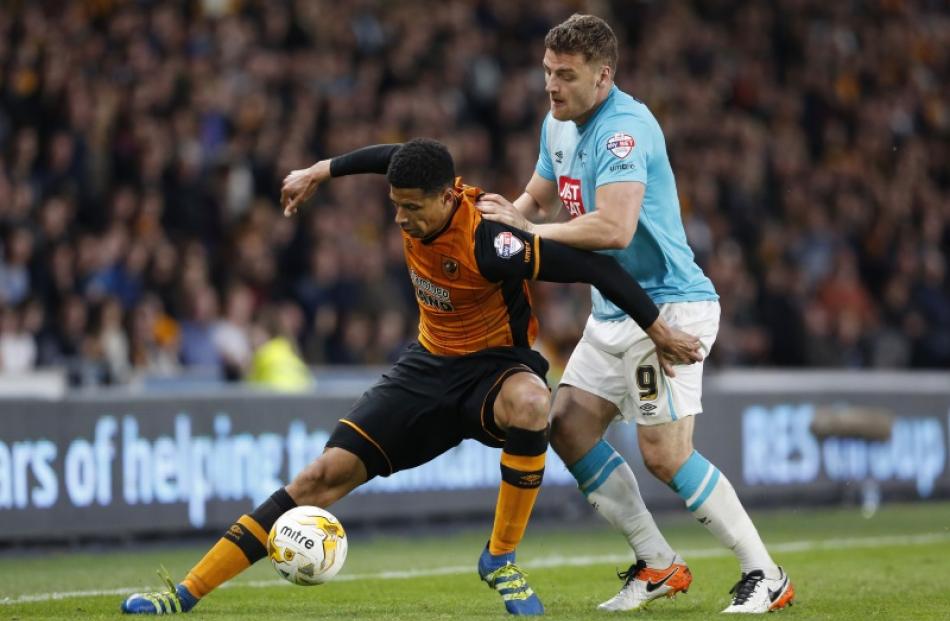 Hull's Curtis Davies controls the ball as Derby's Chris Martin tries to get it off him. Photo:...