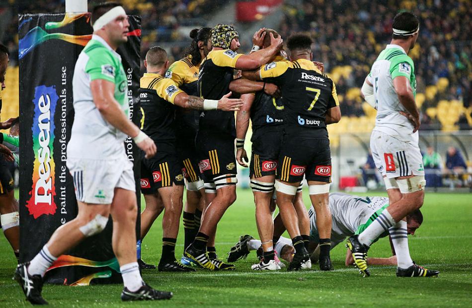 Hurricanes players celebrate a try during their win over the Highlanders. Photo: Getty Images