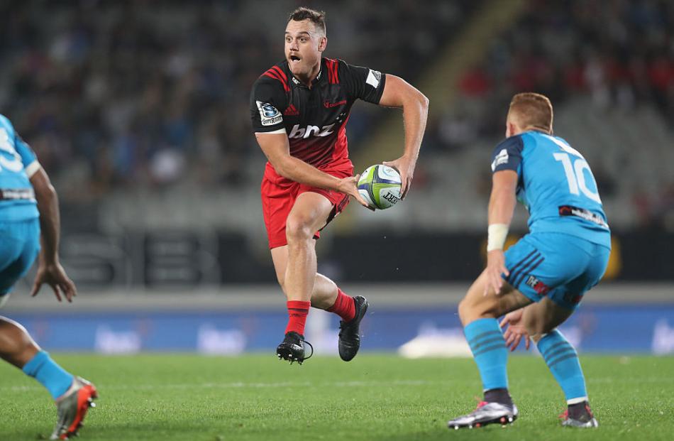 Israel Dagg looks to pass for the Crusaders against the Blues. Photo: Getty Images