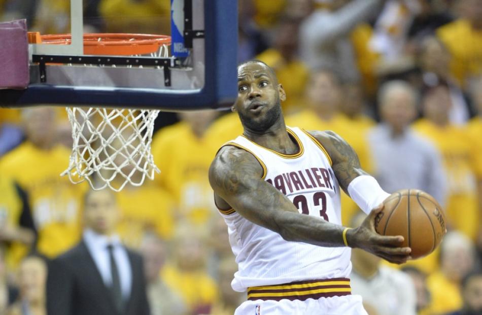LeBron James takes the ball to the hoop for a transition dunk in the Cavaliers' win. Photo: Reuters