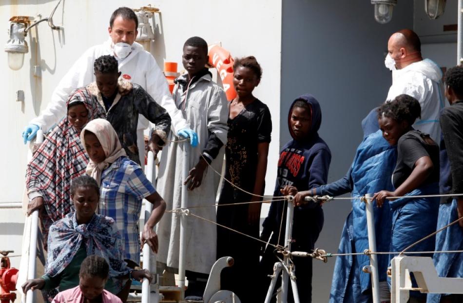 Migrants disembark from the Italian Navy vessel Vega. Photo: Reuters