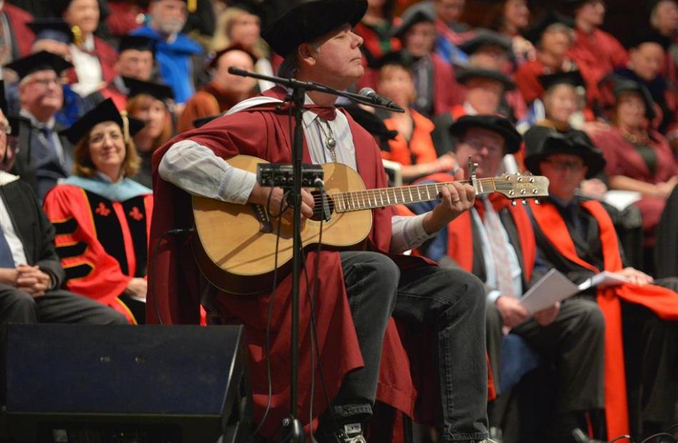 Newly capped doctor of musical arts John Egenes performs his song Up for Air during the first of...