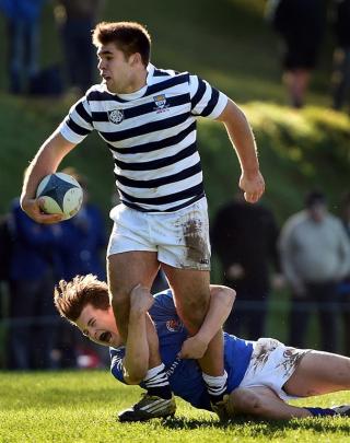 Otago Boys' High School second five-eighth George Thomas is tackled by Southland Boys' High...