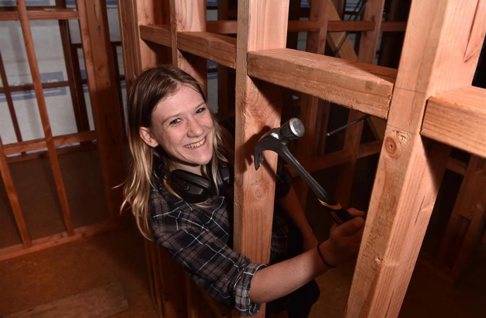 Otago Polytechnic level 4 certificate in carpentry student Megan Roberts works on her class house...