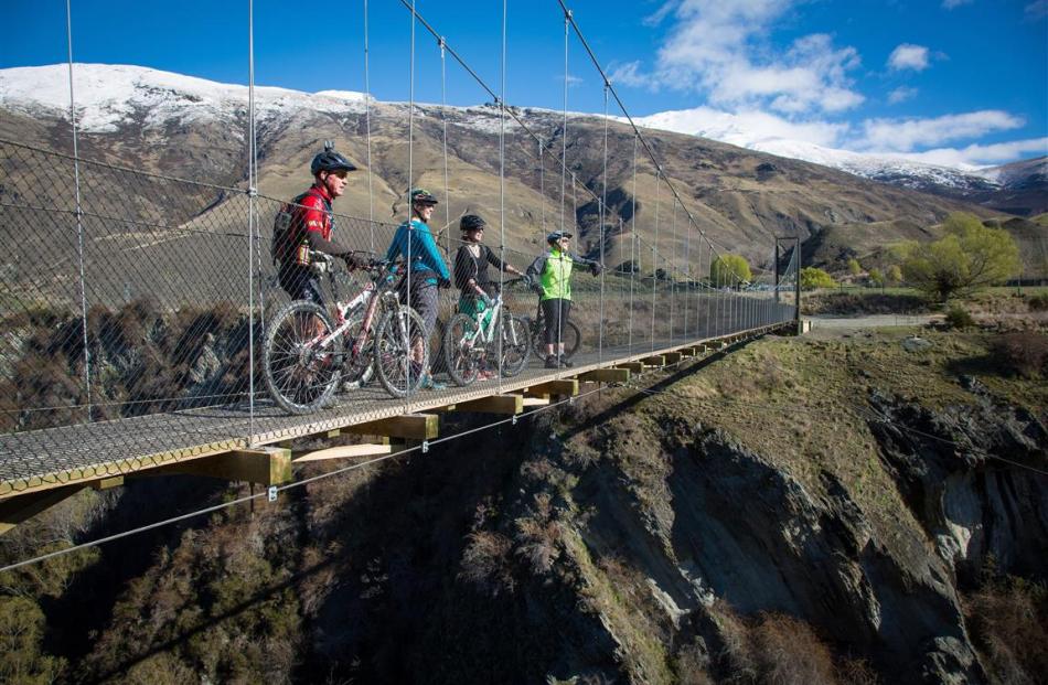 Riders enjoy the views from the Edgar Bridge on the Arrow River Bridges Ride. Photo from...