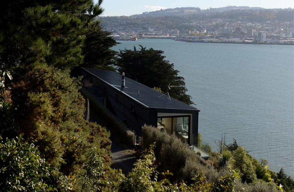 The long narrow shape of this house was dictated by the steep Otago Peninsula site, which drops...