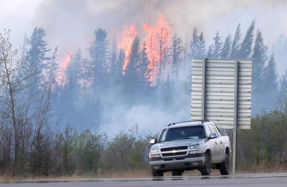 The wildfire burns near Highway 63 south of Fort McMurray. Photo: Reuters